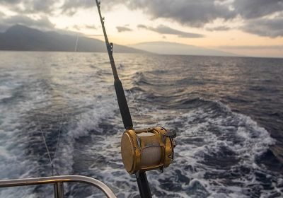 deep-sea-fishing-reel-on-a-boat-during-sunrise-2023-11-27-05-25-24-utc