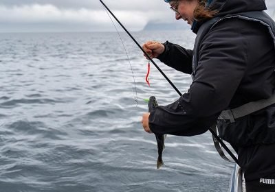 happy-female-angler-displaying-her-fishing-success-2023-12-18-21-15-13-utc